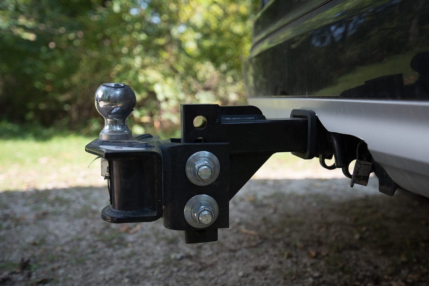 A weight distribution and sway control hitch fitted to a trailer tongue, with spring bars and chains visible